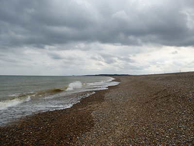 Waves breaking on the shingle beach at Dunwich, Suffolk.