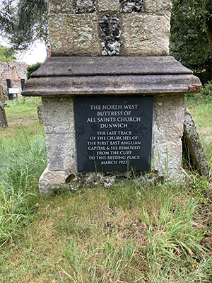 Plaque beneath buttress of All Saints' Church, Dunwich.