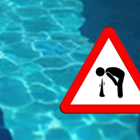 A warning sign about vomiting in the swimming pool.