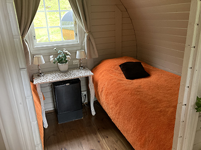 Bedroom in the barrel glamping pod at the Vestmannaeyjar campsite.
