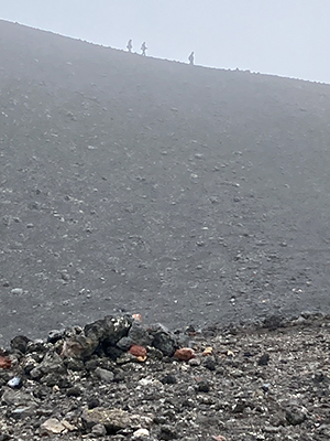 Walkers on the ridge of Eldfell volcano.