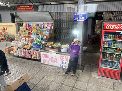 Food seller on station platform, Vietnam.